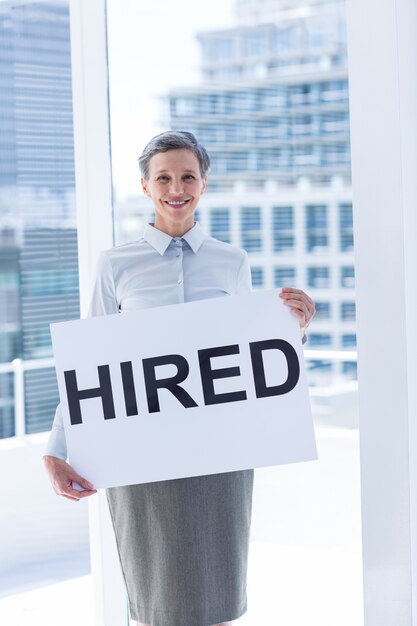 Businesswoman holding a signboard hired