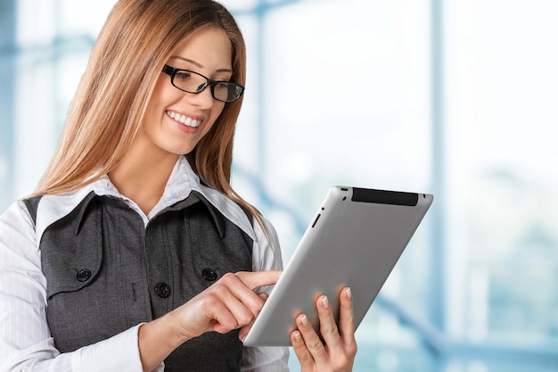 Businesswoman holding tablet pc isolated on white