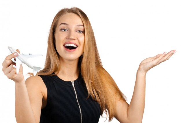 Businesswoman holding a toy airplane