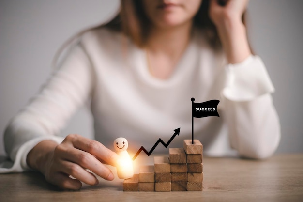 Businesswoman holding Wooden figures climbing on stairs, success, Career development, and job concept