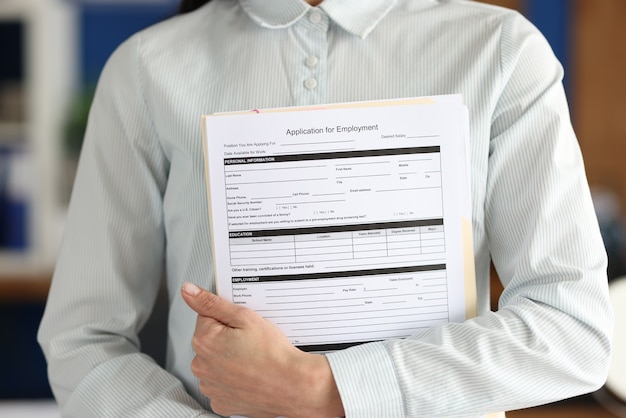 Photo businesswoman holds application form employment document in hands