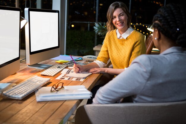 Businesswoman interacting with colleague