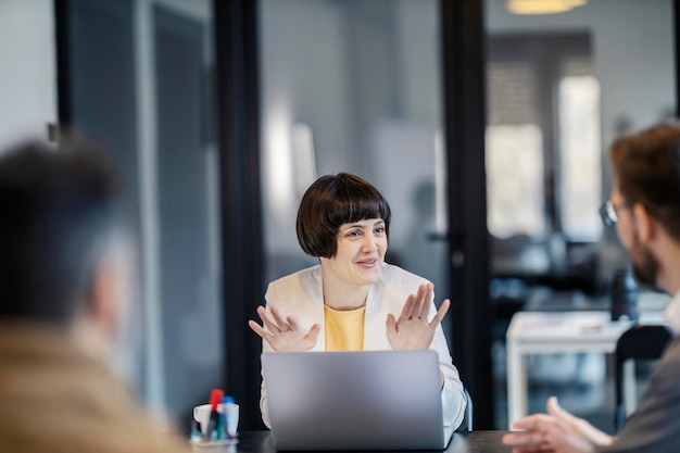 A businesswoman is explaining business strategy at boardroom