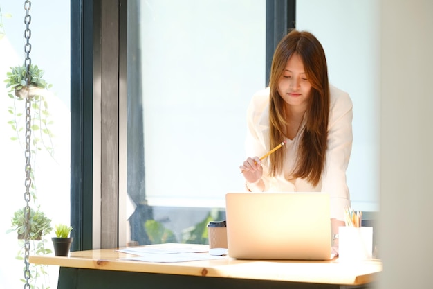 Businesswoman is working at office and using laptop