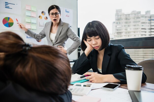 the businesswoman is yelling at her colleagues who doze off in the meeting.