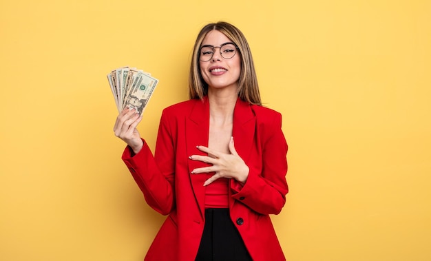 Businesswoman laughing out loud at some hilarious joke. dollar banknotes concept