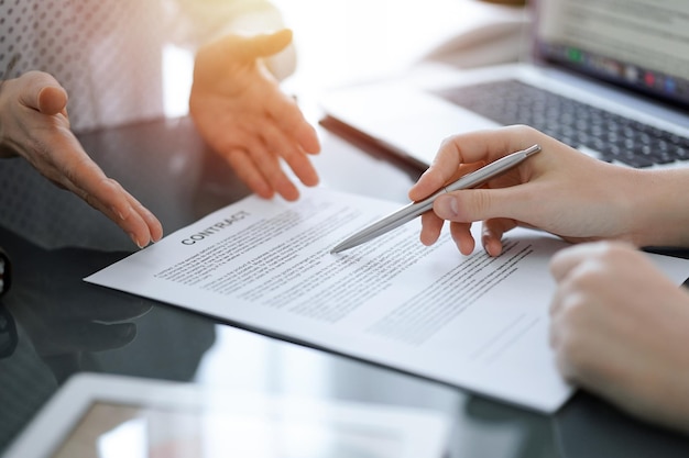 Photo businesswoman lawyer pointing into contract special points admitting something for colleague or client at meeting. business people teamwork and partnership.