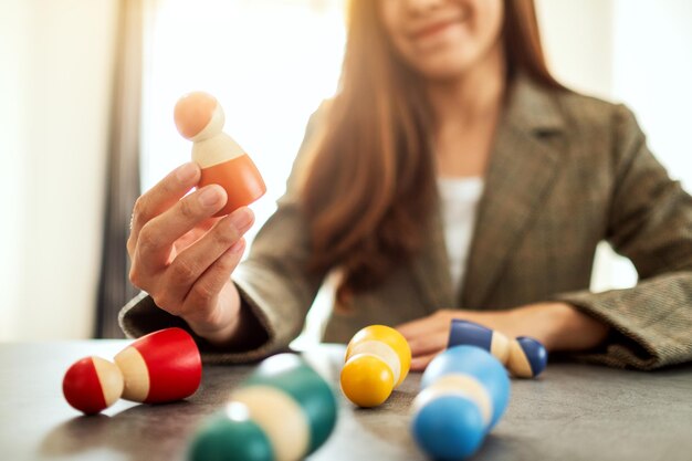 Businesswoman leader choosing wooden people from a group of employees in office