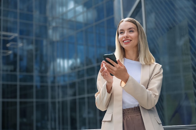 Businesswoman. Long-haired blonde woman with a phone in hand