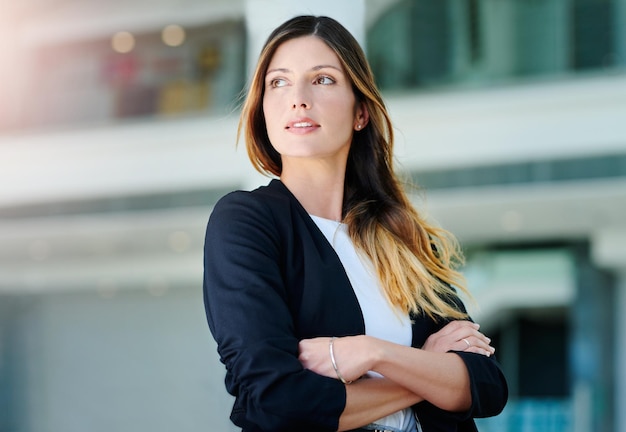 Businesswoman looking away looking away while standing outdoors