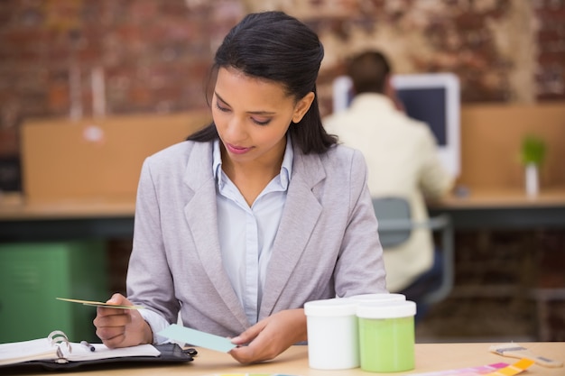 Businesswoman looking at diary in office