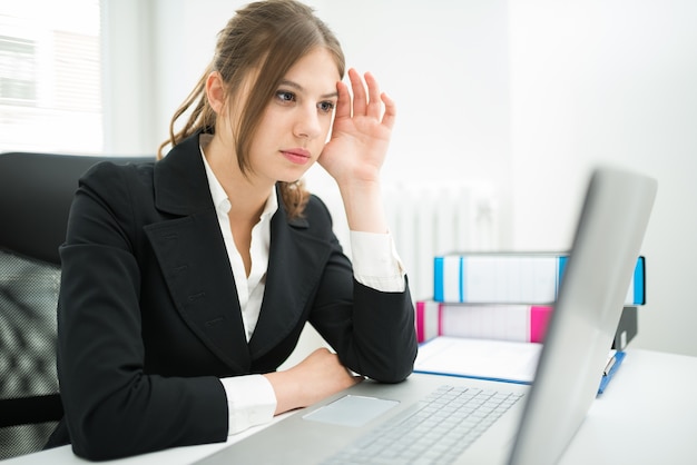 Businesswoman looking at her computer monitor