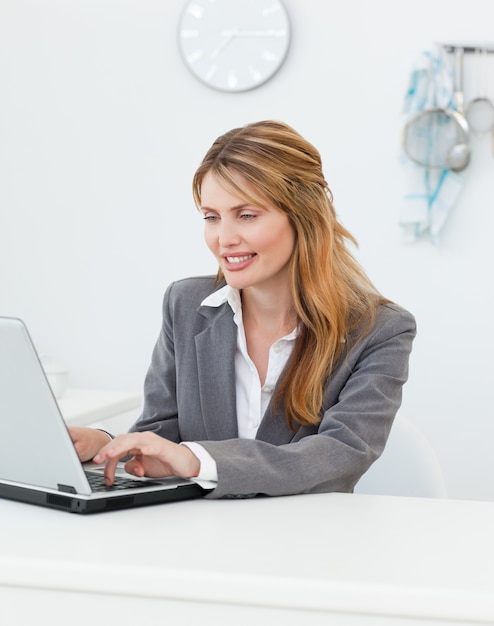 Businesswoman looking at her laptop