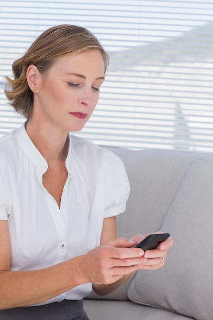 Businesswoman looking at her mobile phone