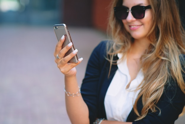 Businesswoman looking into the phone