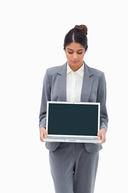 Businesswoman looking at laptop in her hands