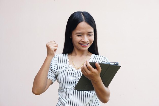 Businesswoman looking at a portable computer monitor Glad to have more profit