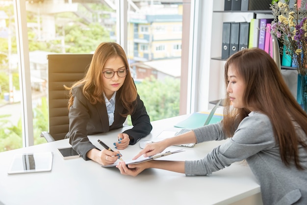 Businesswoman meeting and consulting together in office.