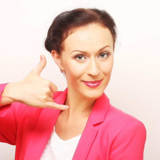 Businesswoman miming a phone call using the hand