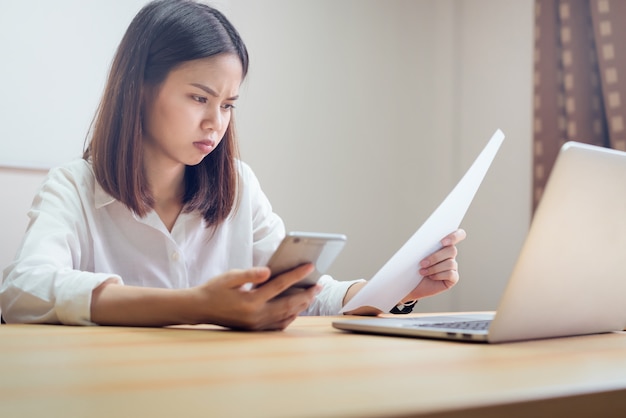 Businesswoman in office and use computer to perform financial accounting. To plan advance budget.