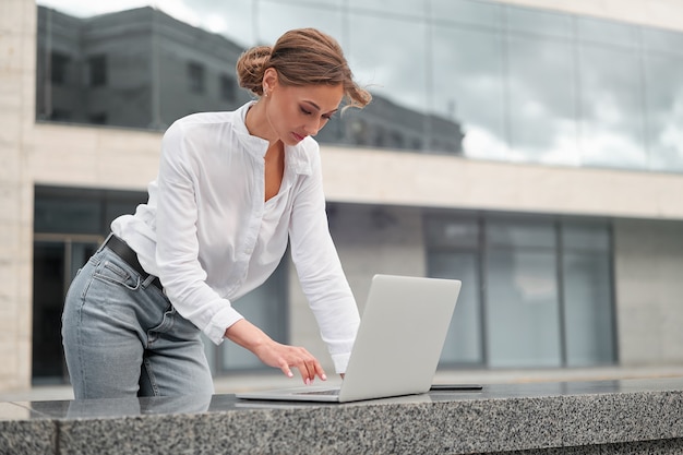 Businesswoman outdoor with laptop