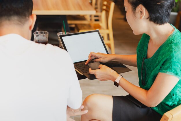 Businesswoman pay bills online on credit card using laptop computer at cafe