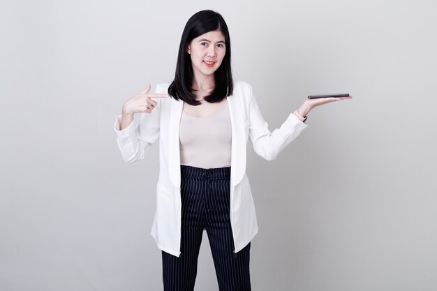 Businesswoman pointing her finger on white 