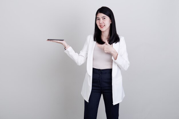 Businesswoman pointing her finger on white 