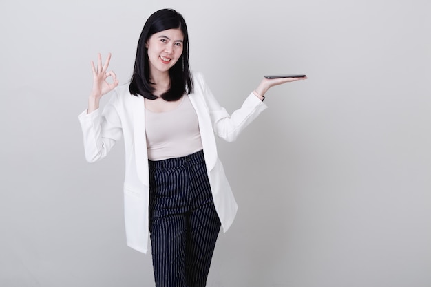 Businesswoman pointing her finger on white 