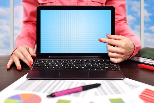 Businesswoman pointing to laptop