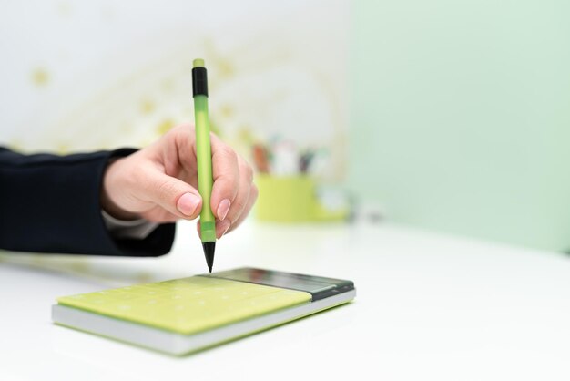 Businesswoman Pointing With Pen On Important Message With Calculator And Notebook On Desk Woman Presenting News On Table With Notepad Executive Displaying Recent News