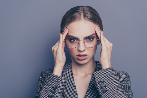 Businesswoman posing against the grey wall