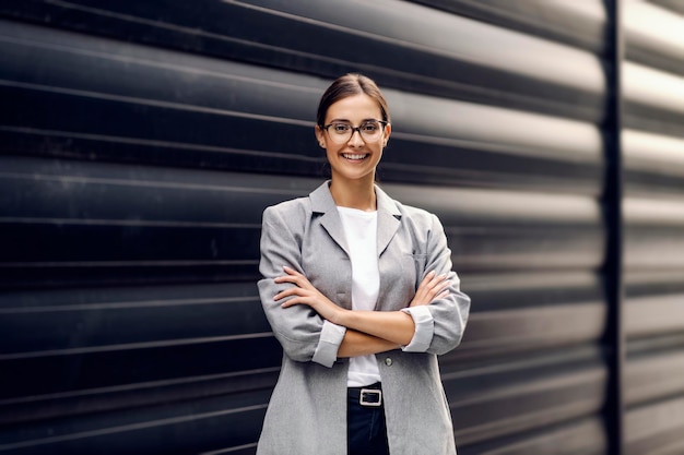 A businesswoman posing outside