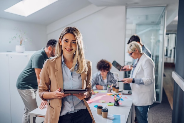 Businesswoman posing and smiling during a meeting in an office