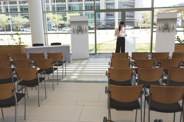 Businesswoman practising speech in empty conference room