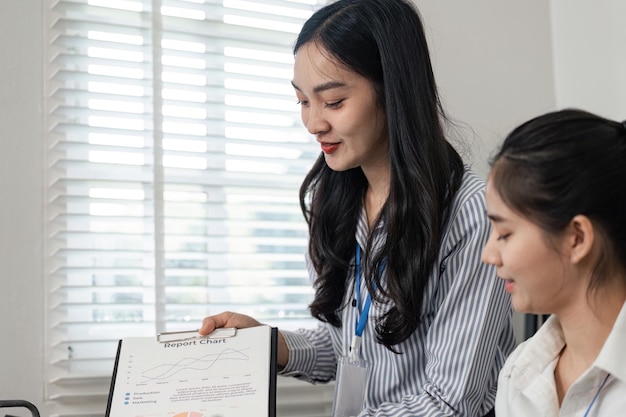 businesswoman presenting a report chart to her colleague in a collaborative office