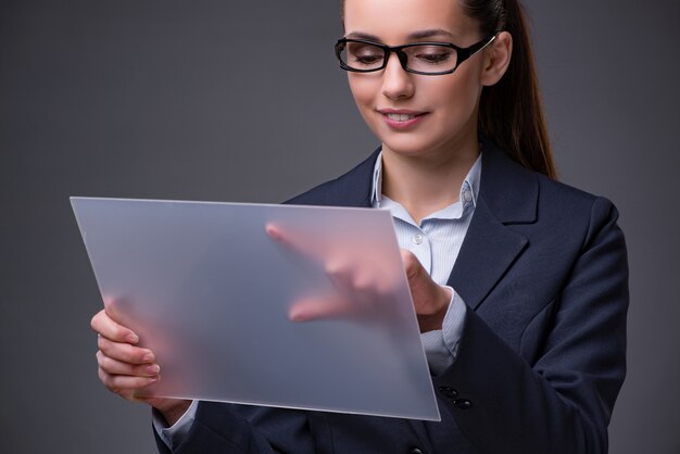 Businesswoman pressing buttons on tablet