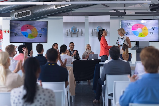 businesswoman receiving award in a business seminar