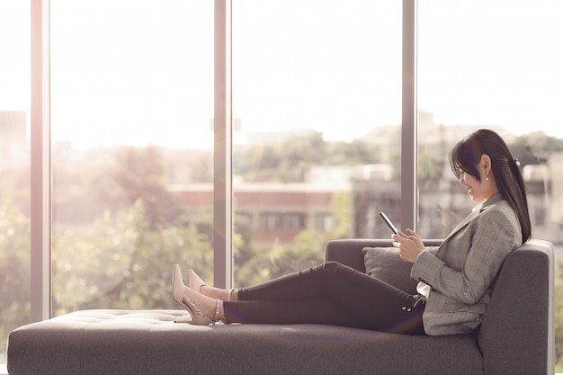 Businesswoman relaxing on sofa.