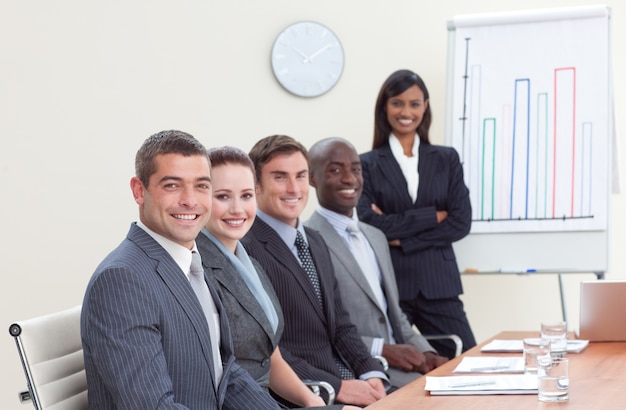 Businesswoman reporting to sales figures to her colleagues