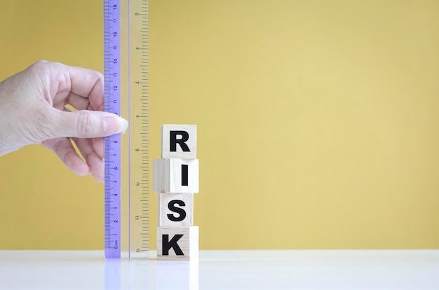 Businesswoman's hand measure risk with a ruler