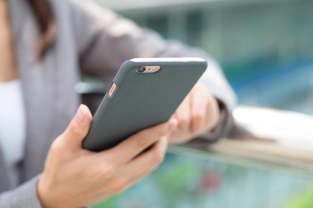 Businesswoman sending text message on cellphone