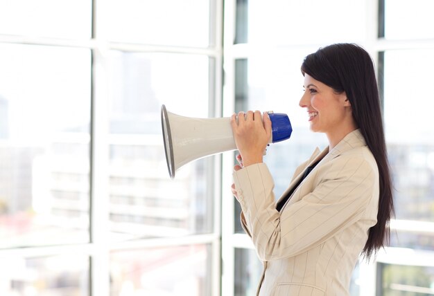 Businesswoman shouting through megaphone