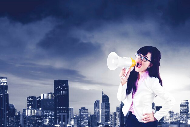 Businesswoman shouting through a megaphone