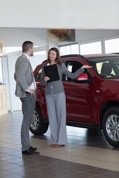 Businesswoman showing a car