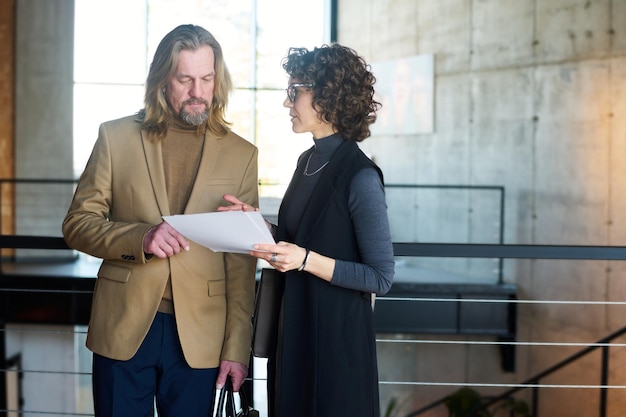 Businesswoman showing and explaining contract terms to business partner