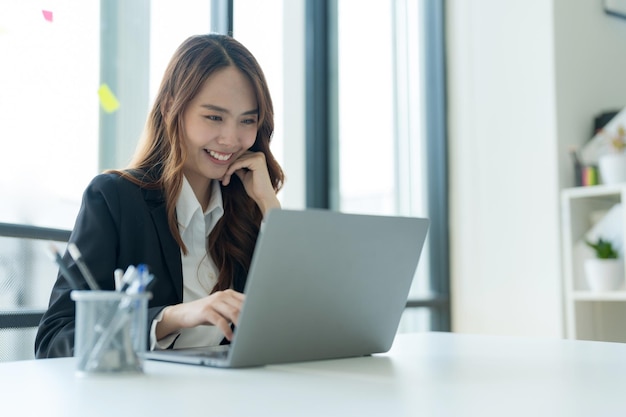 Businesswoman showing joy at her desk successful