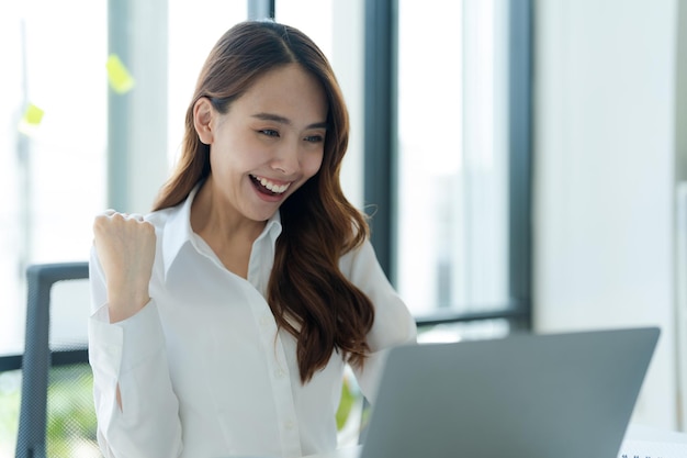 Businesswoman showing joy at her desk