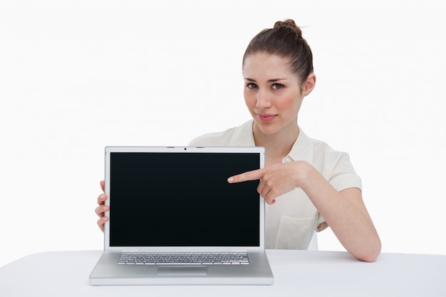 Businesswoman showing a laptop