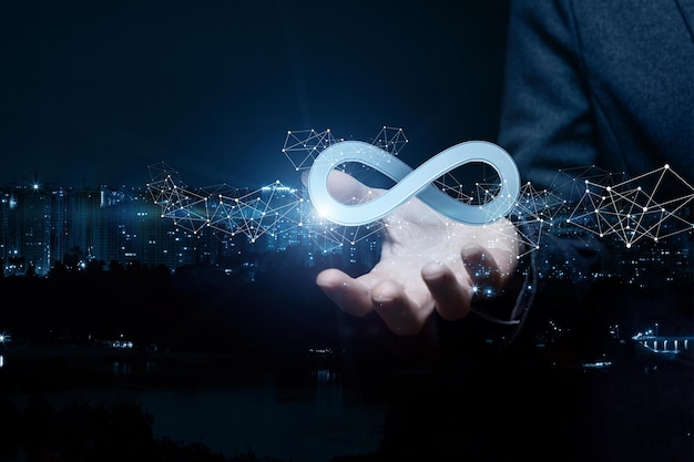 Businesswoman shows sign of infinity on the background of the city